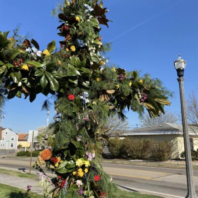 Fresh flowers and greens on the cross